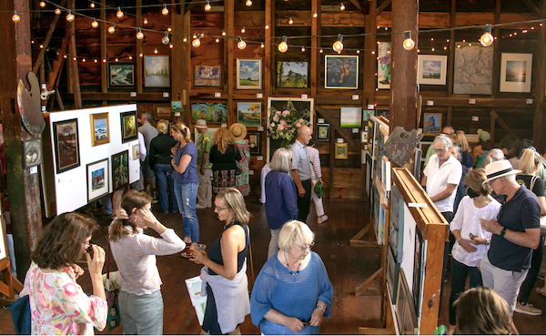 Art in the Barn, colorful barn full of visitors and artwork