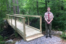 Eagle Scout next to new bridge at Barrett