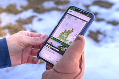 hand holding phone with GreenbeltGo trails app