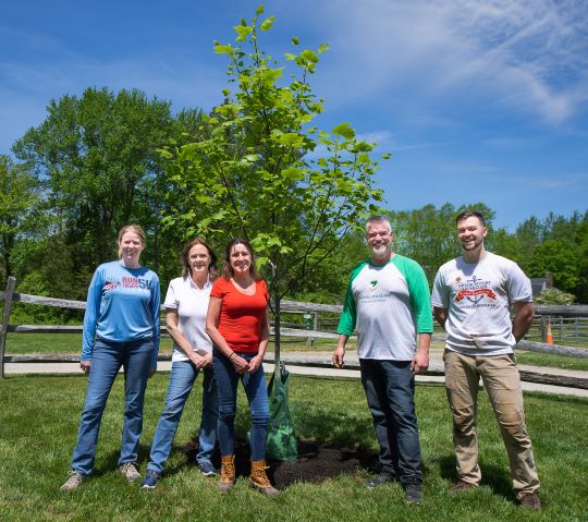 Volunteers from Institution for Savings by new trees 